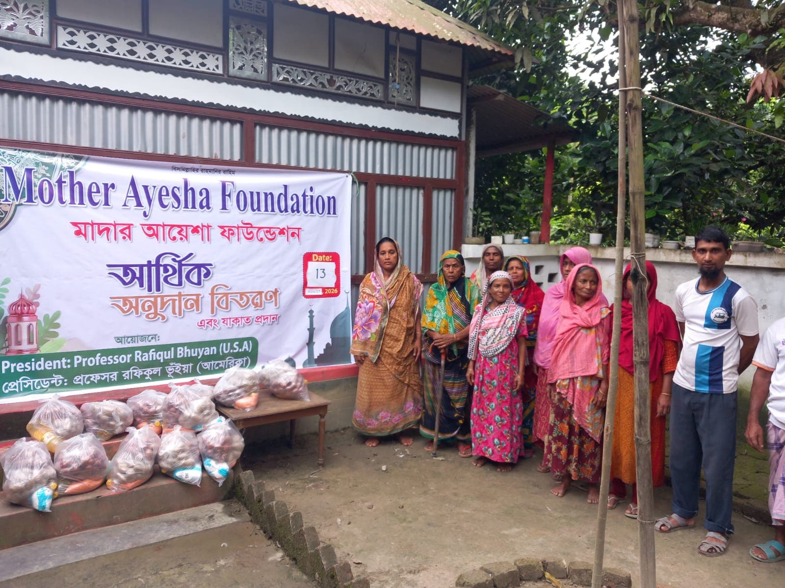 Community members receiving food assistance during a Mother Ayesha Foundation relief program